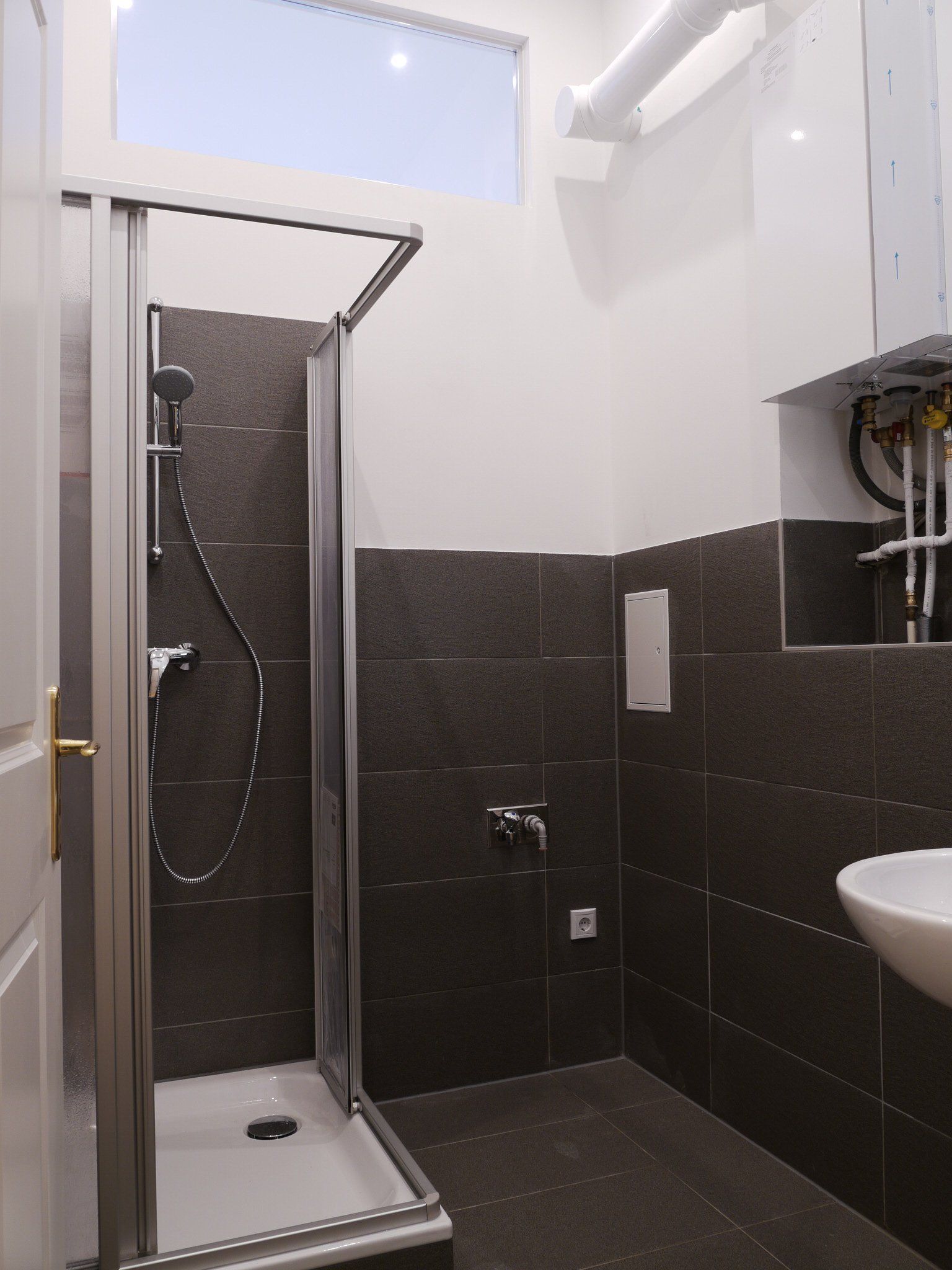 Ein Badezimmer mit ebenerdiger Dusche und Waschbecken