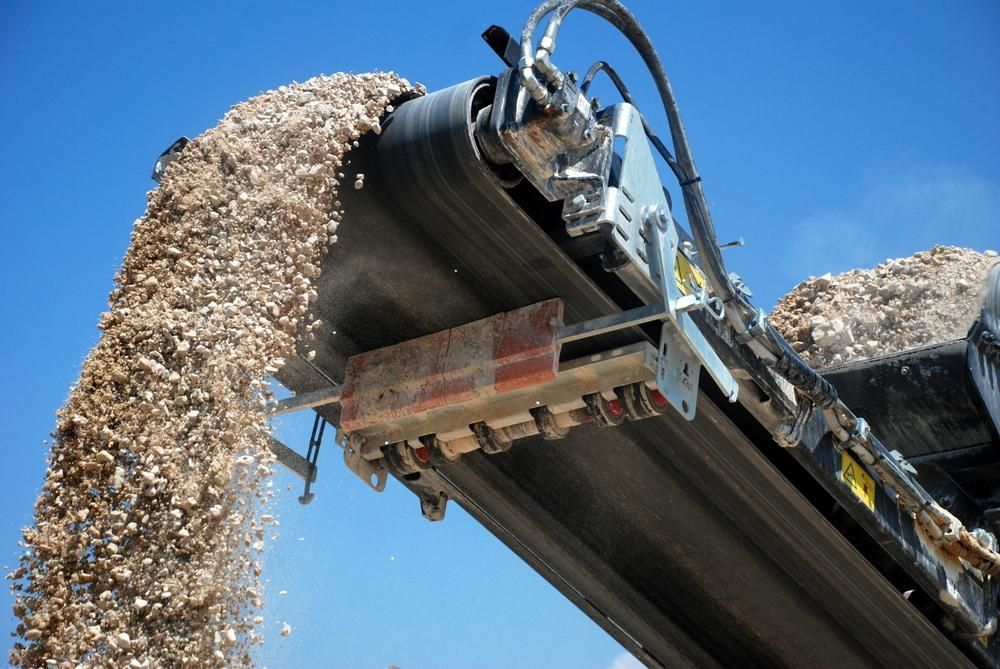 A Conveyor Belt is Being Used to Carry a Pile of Gravel — Chooks Sand And Gravel In Paget, QLD