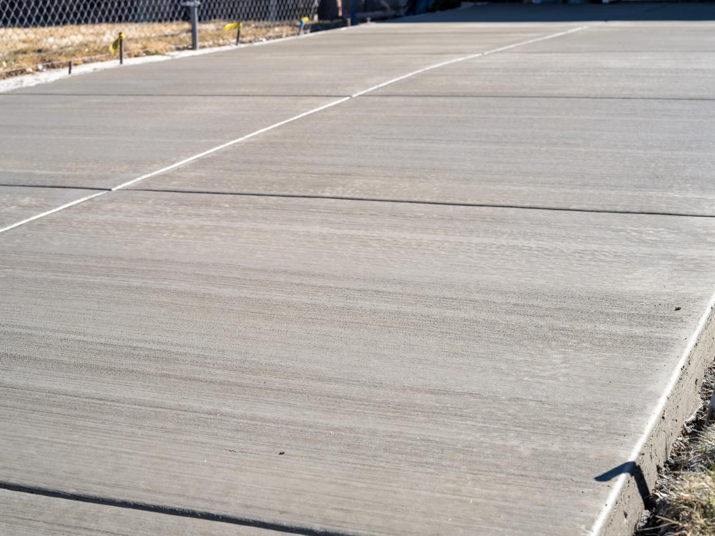 A Concrete Driveway With a Fence in the Background — Chooks Sand And Gravel In Cannonvale, QLD