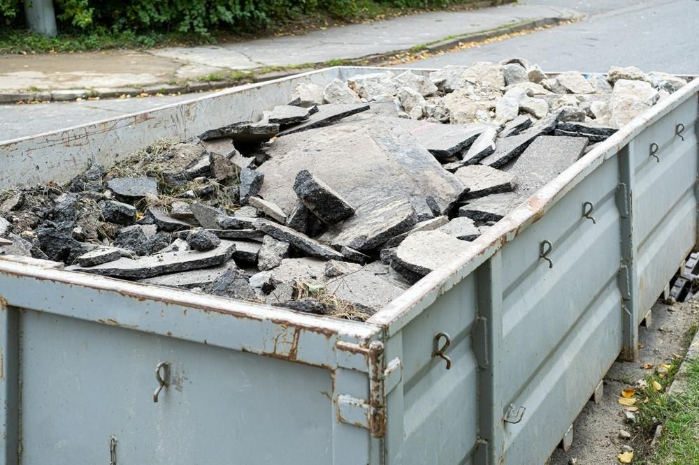 A Dumpster Filled With Rocks and Dirt is Sitting on the Side of the Road — Chooks Sand And Gravel In Paget, QLD