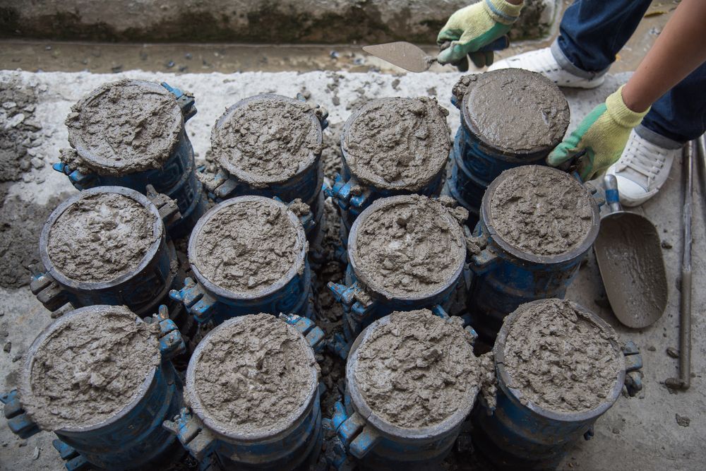 A Person is Working on a Pile of Concrete Cylinders — Chooks Sand And Gravel In Paget, QLD
