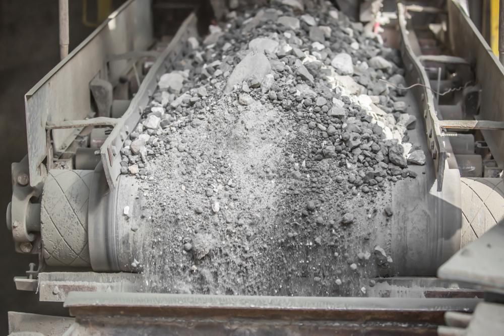 A Conveyor Belt Filled With Rocks in a Factory — Chooks Sand And Gravel In Paget, QLD