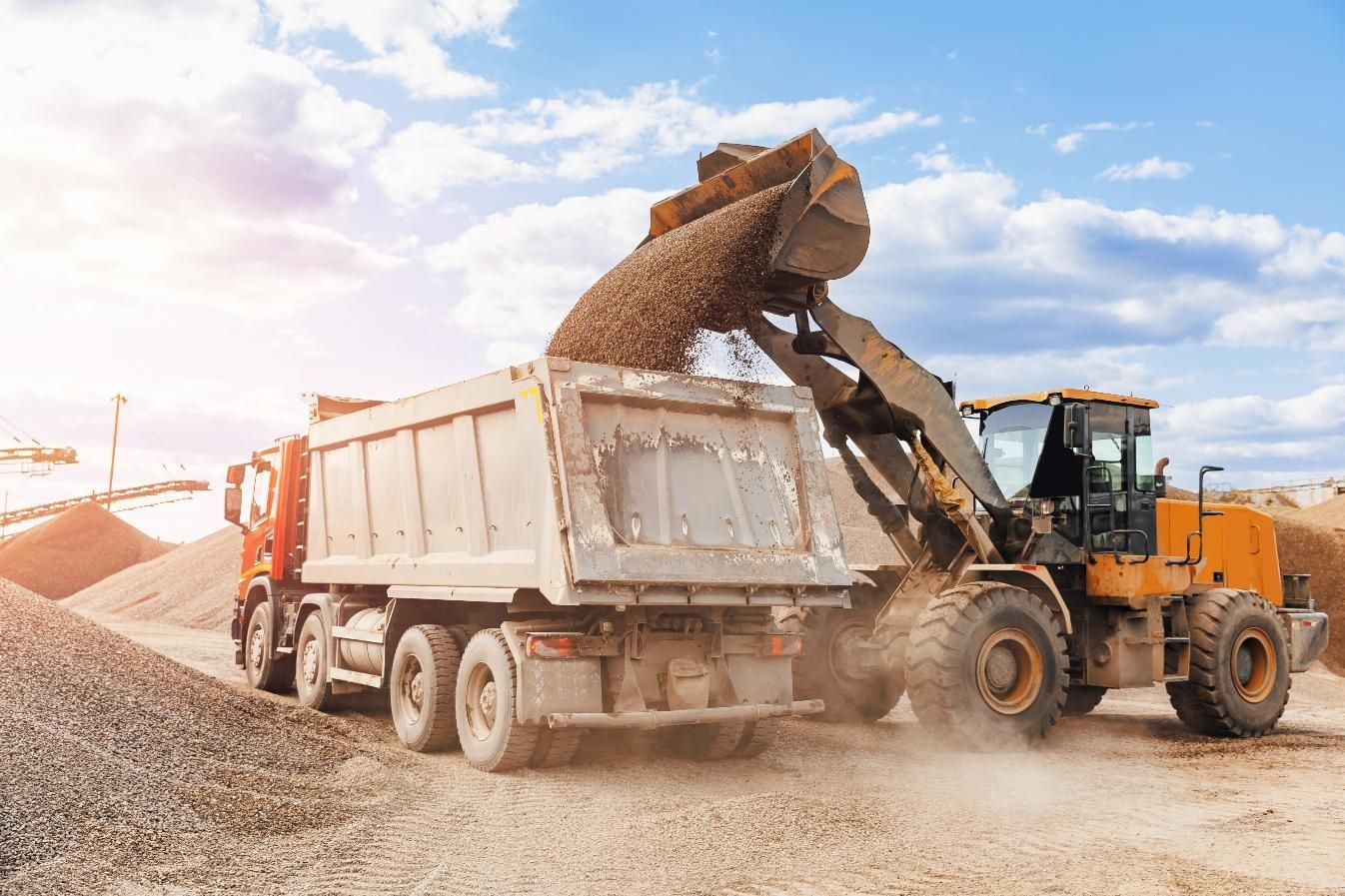 A Dump Truck is Being Loaded With Gravel by a Bulldozer — Chooks Sand And Gravel In Paget, QLD