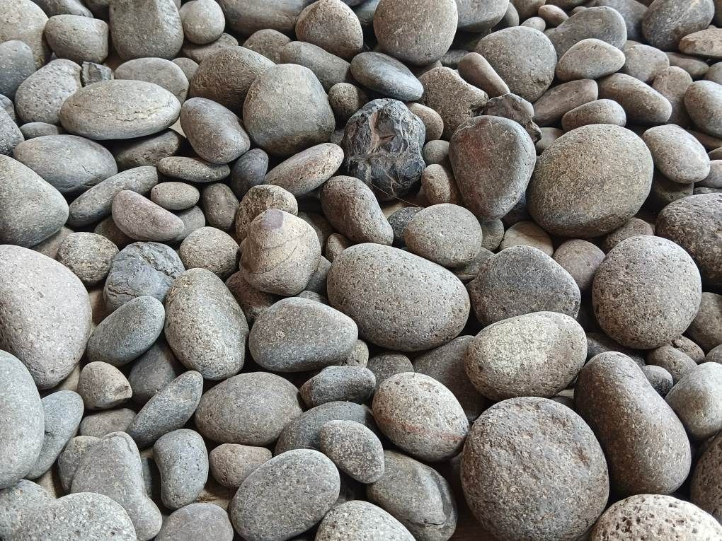 A Pile of Gray Rocks With White Lines on Them — Chooks Sand And Gravel In Paget, QLD