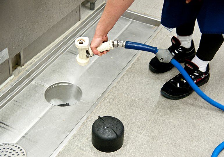 Cleaning Floor Drain In The Kitchen — Sergeant Bluff, IA — Speedy Rooter Plumbing