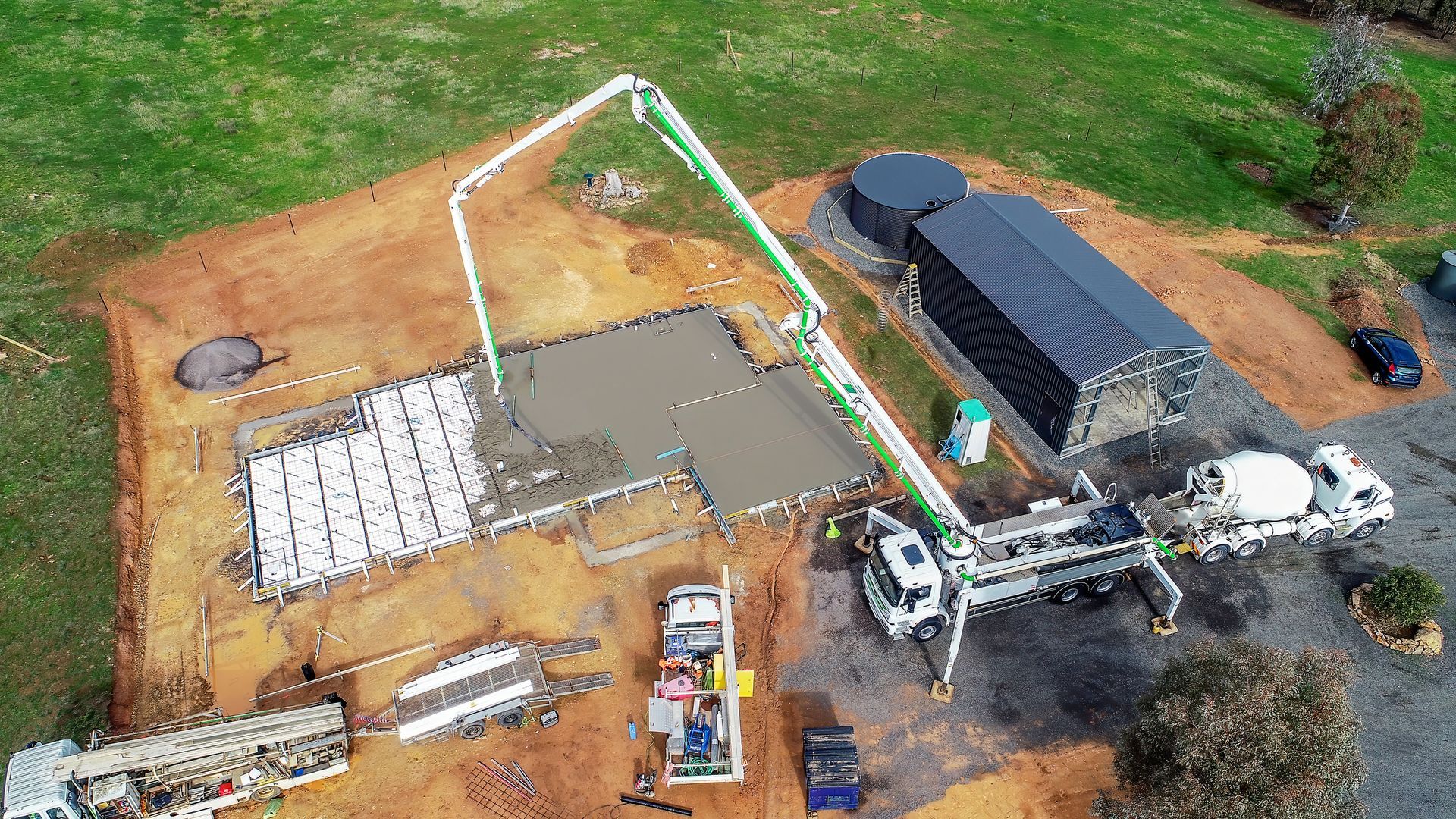 Aerial view of an ongoing concrete pumping service for a commercial property.