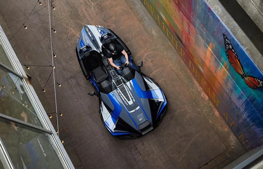 An aerial view of a person riding a motorcycle on a street.
