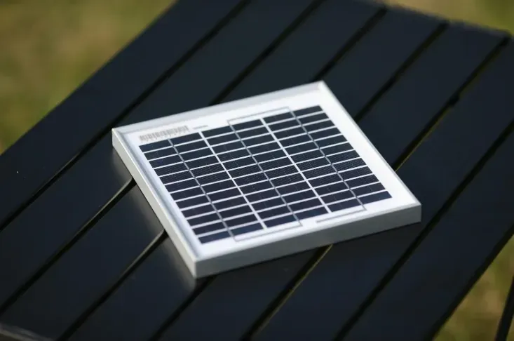 Small Solar Panel on a Black Slatted Surface