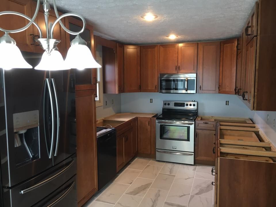 A kitchen with stainless steel appliances and wooden cabinets