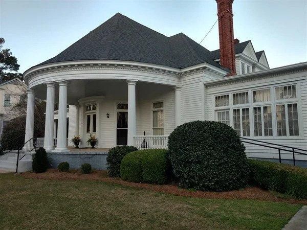 A large white house with a porch and columns