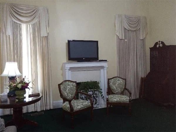 A living room with two chairs and a flat screen tv
