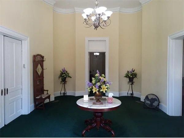 A room with a round table and flowers on it