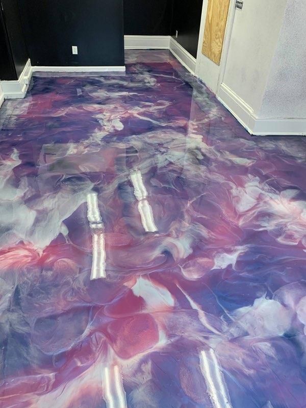 A purple and white marble floor in a room.