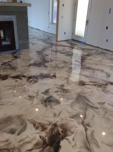 A living room with a marble floor and a fireplace.