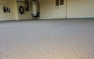 A garage with a concrete floor and a water heater.