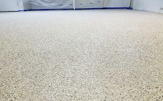 A close up of a white carpeted floor in a room.