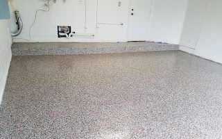 A garage with a concrete floor and white walls.