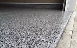 A close up of a gray concrete floor in a garage.
