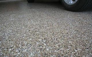 A car is parked in a garage with a concrete floor.