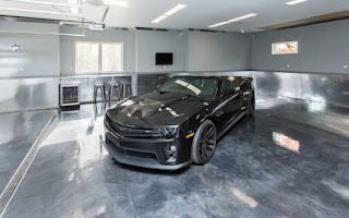 A black car is parked in a garage.
