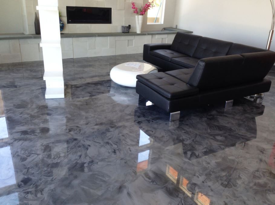 A living room with a black couch and a white coffee table