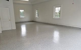 A large empty room with a shiny floor and white walls.