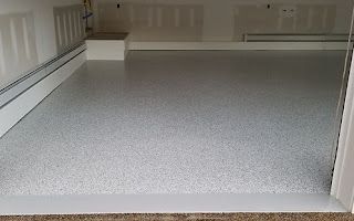 A garage with a white floor and white walls.