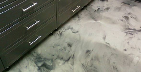 A close up of a marble floor with drawers in the background.