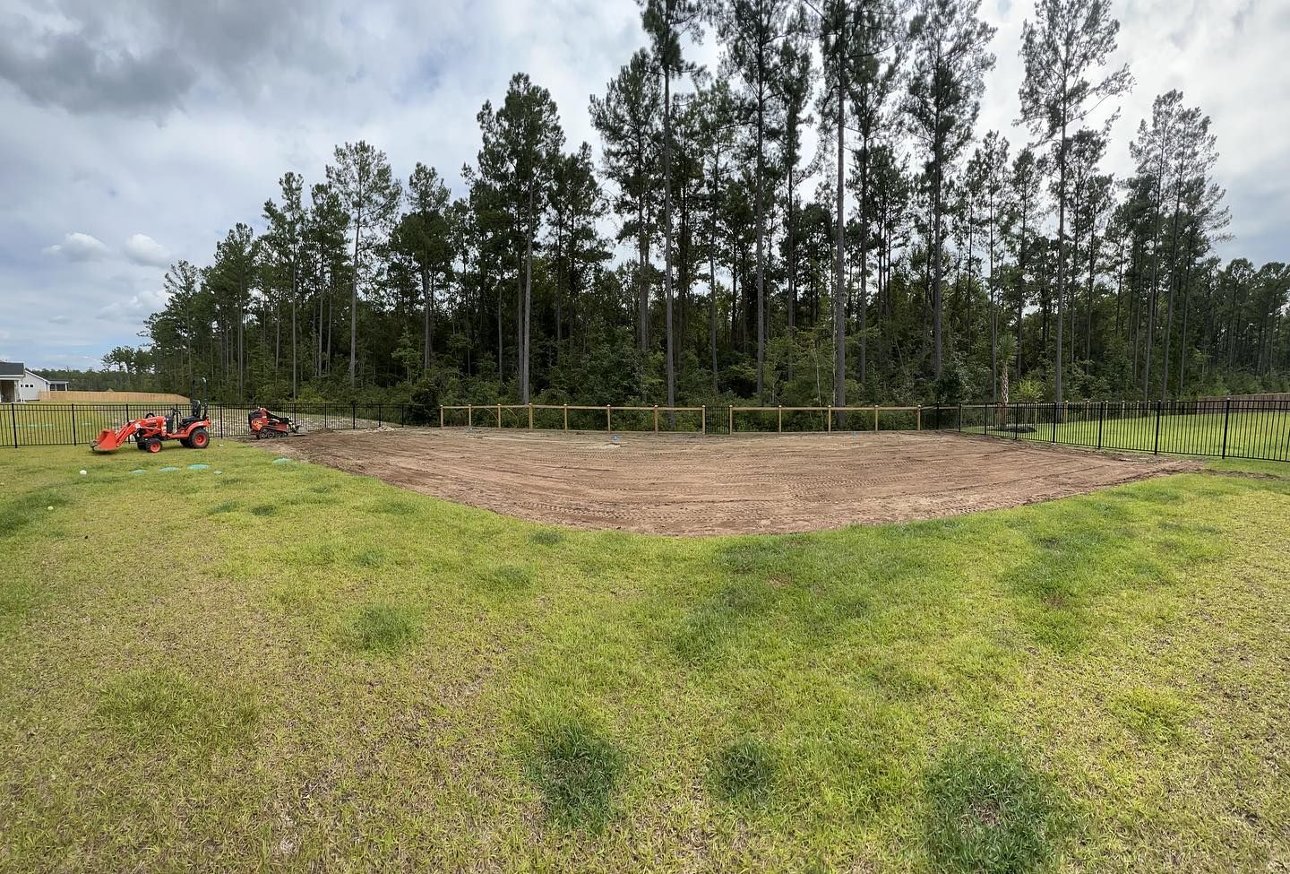 A large grassy field with trees in the background - Mount Pleasant, SC - C&B Landscape LLC