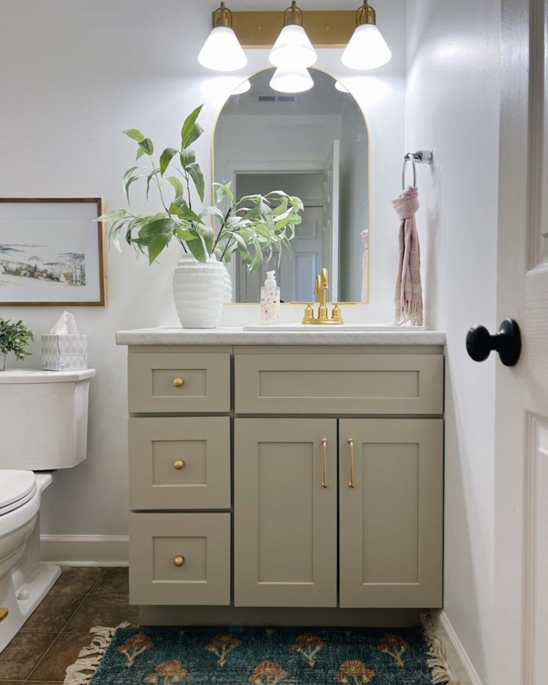 A bathroom with a sink , toilet , and mirror.