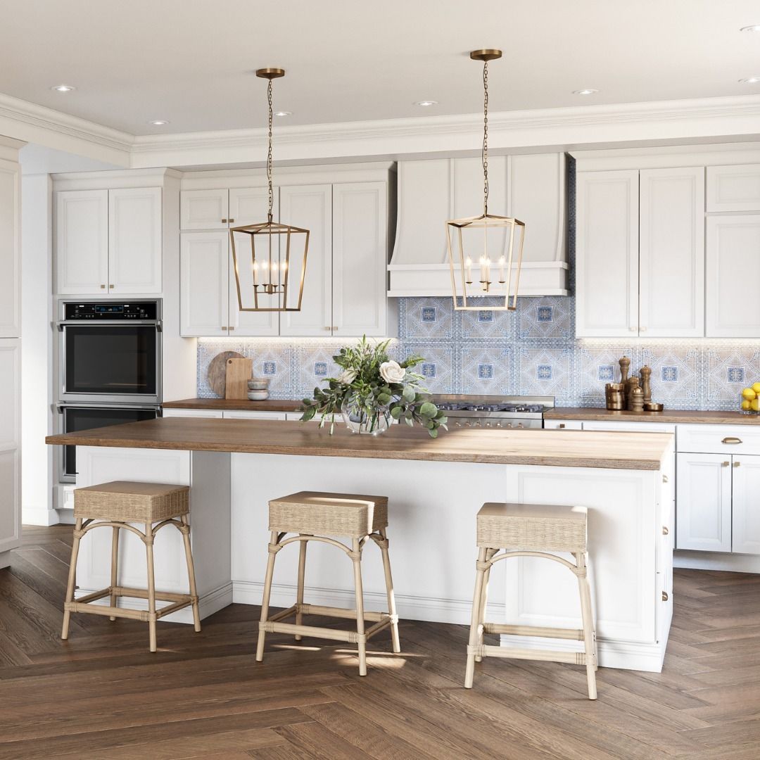 A kitchen with white cabinets and wooden floors