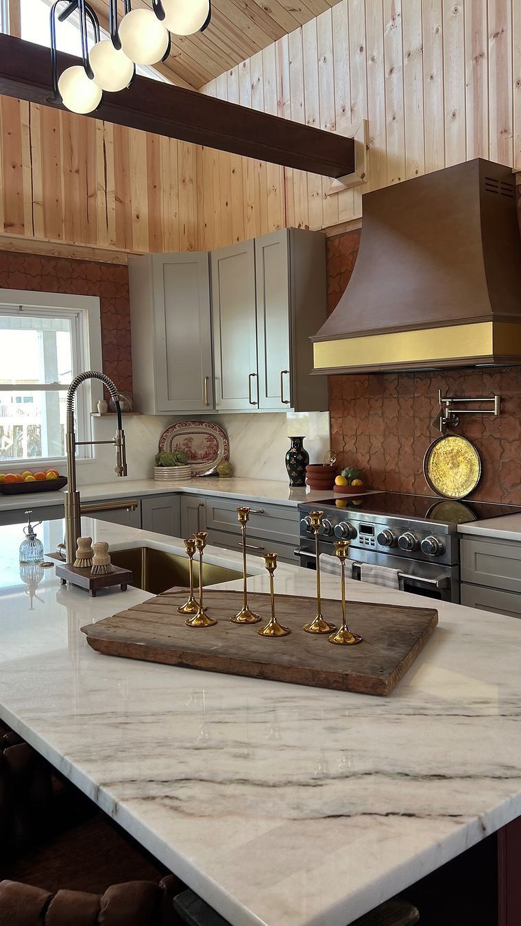 A kitchen with a wooden cutting board on the counter.