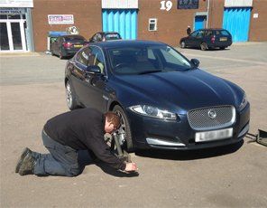 A new tyre being fitted to a Jaguar