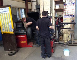 Some of the team fitting tyres to wheels