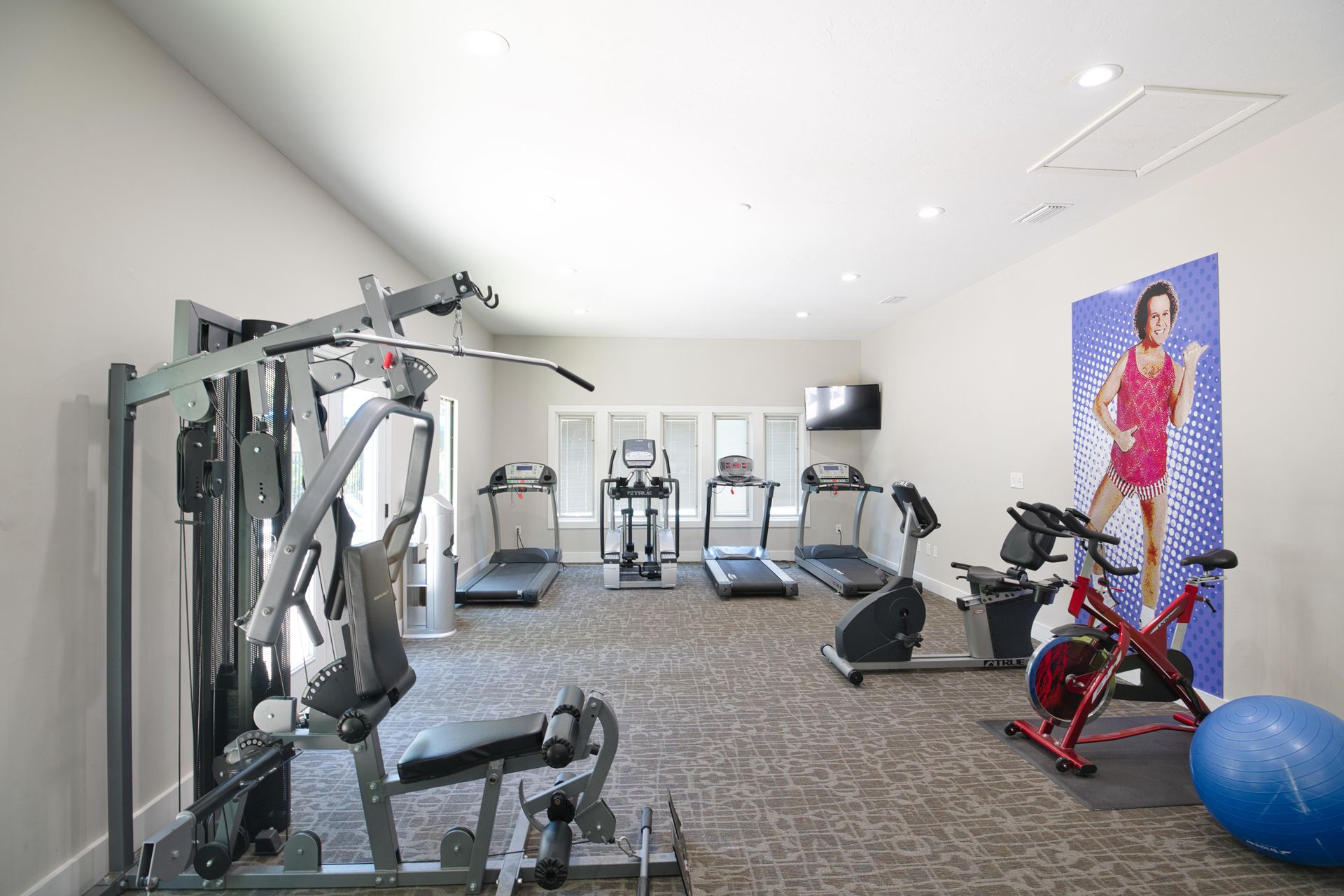 A gym with a picture of a woman on the wall.