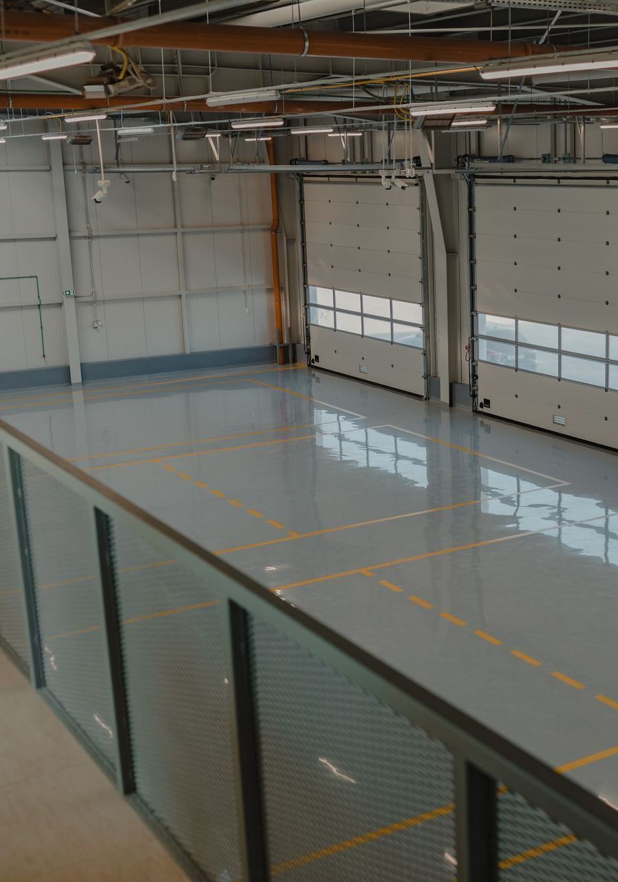 A large empty warehouse with a glass railing