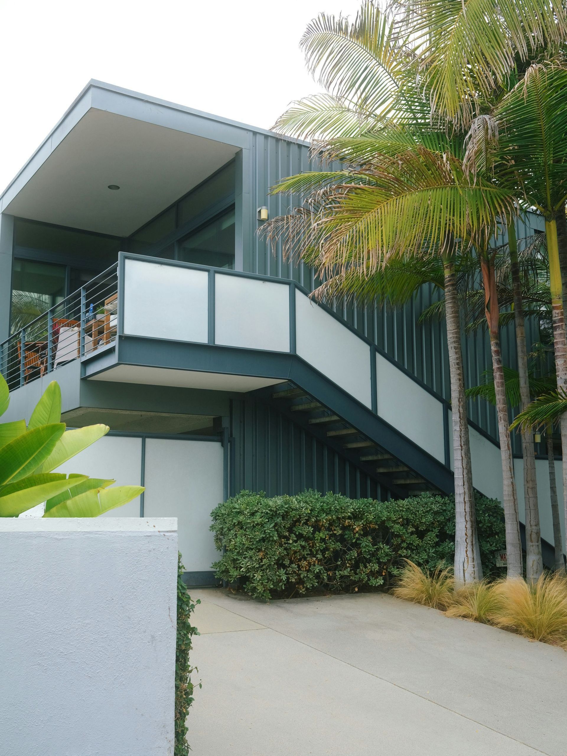 A building with stairs leading up to the second floor