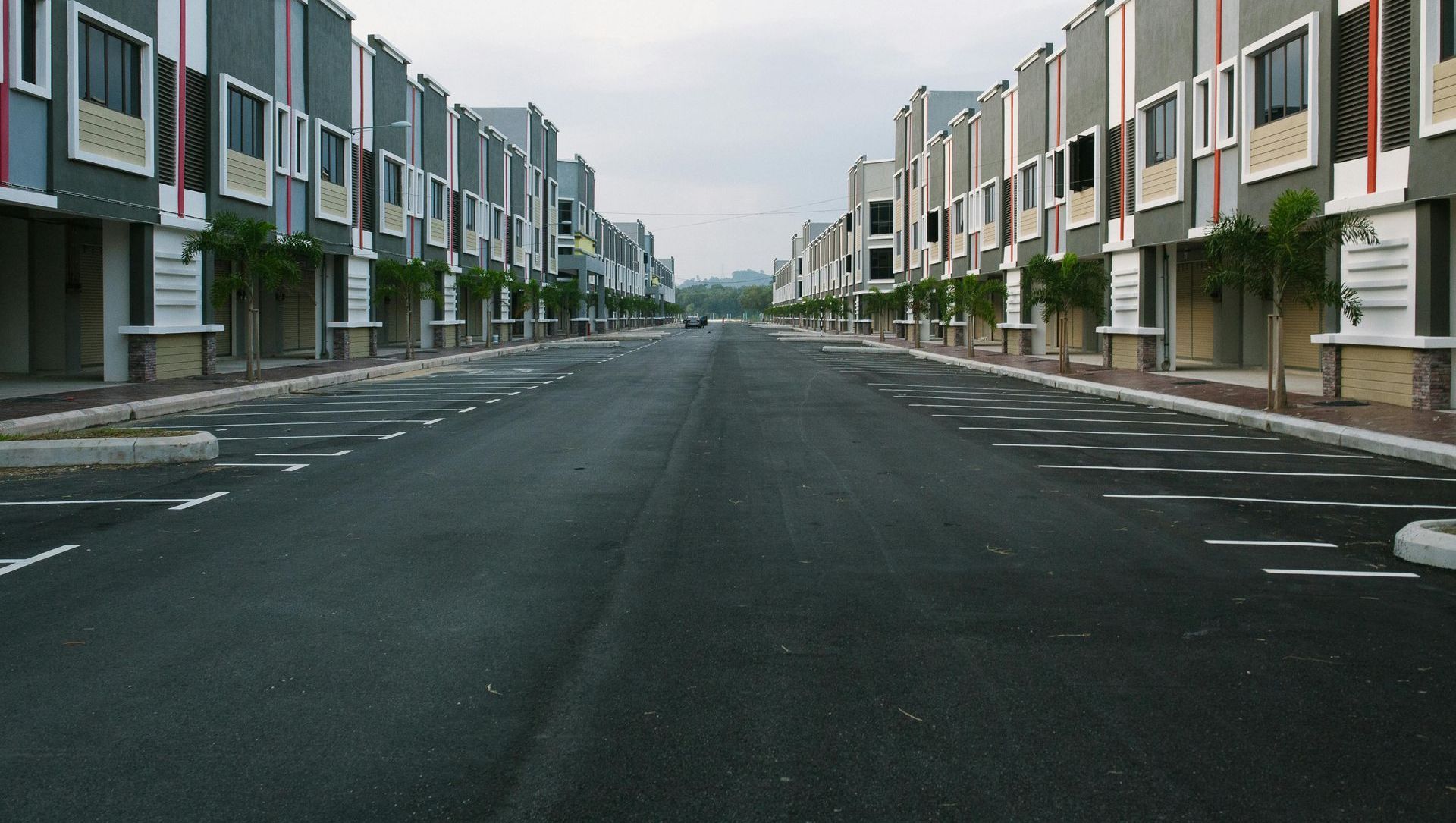 An empty street with a row of buildings on both sides