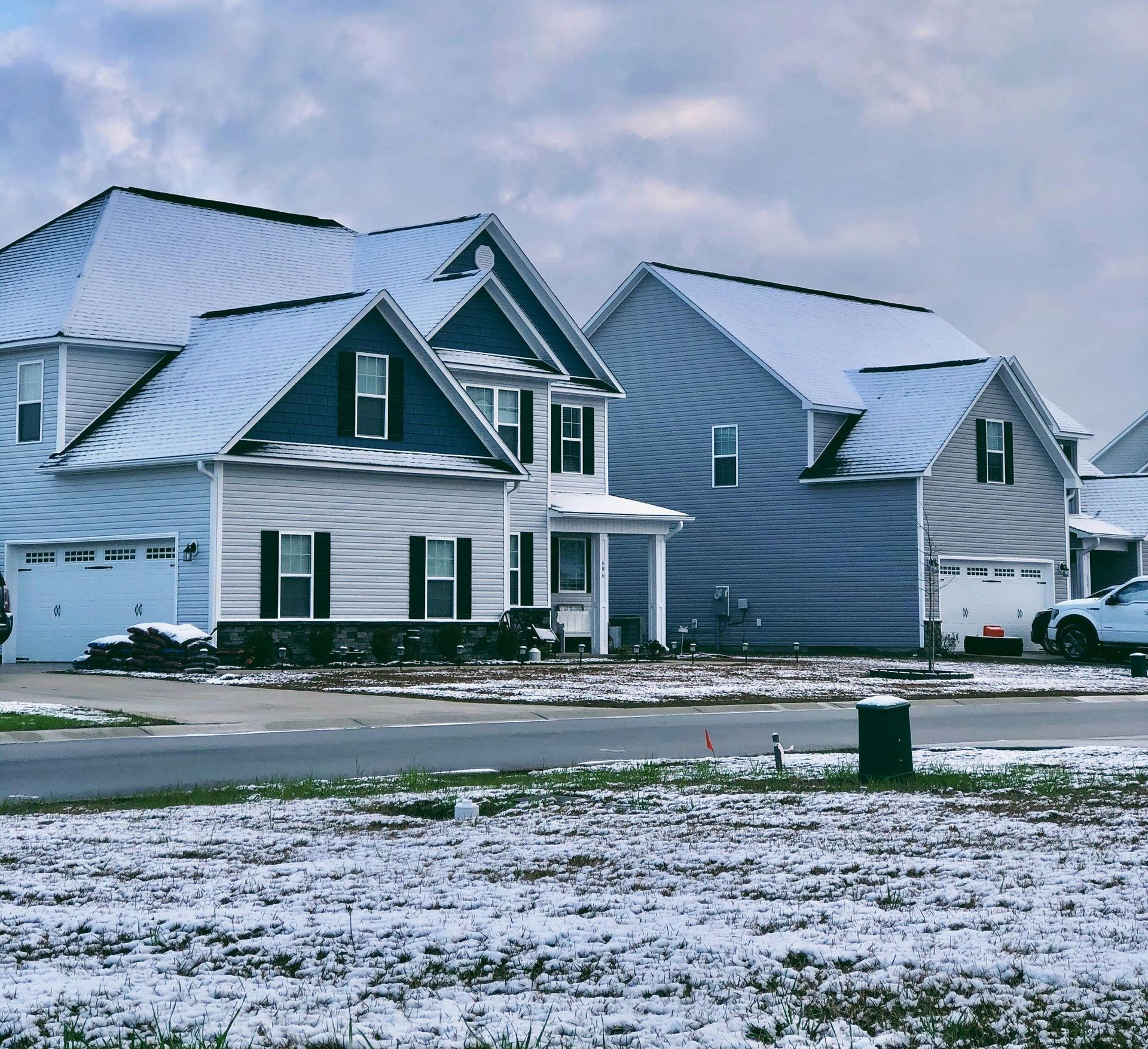 A row of houses with snow on the roofs