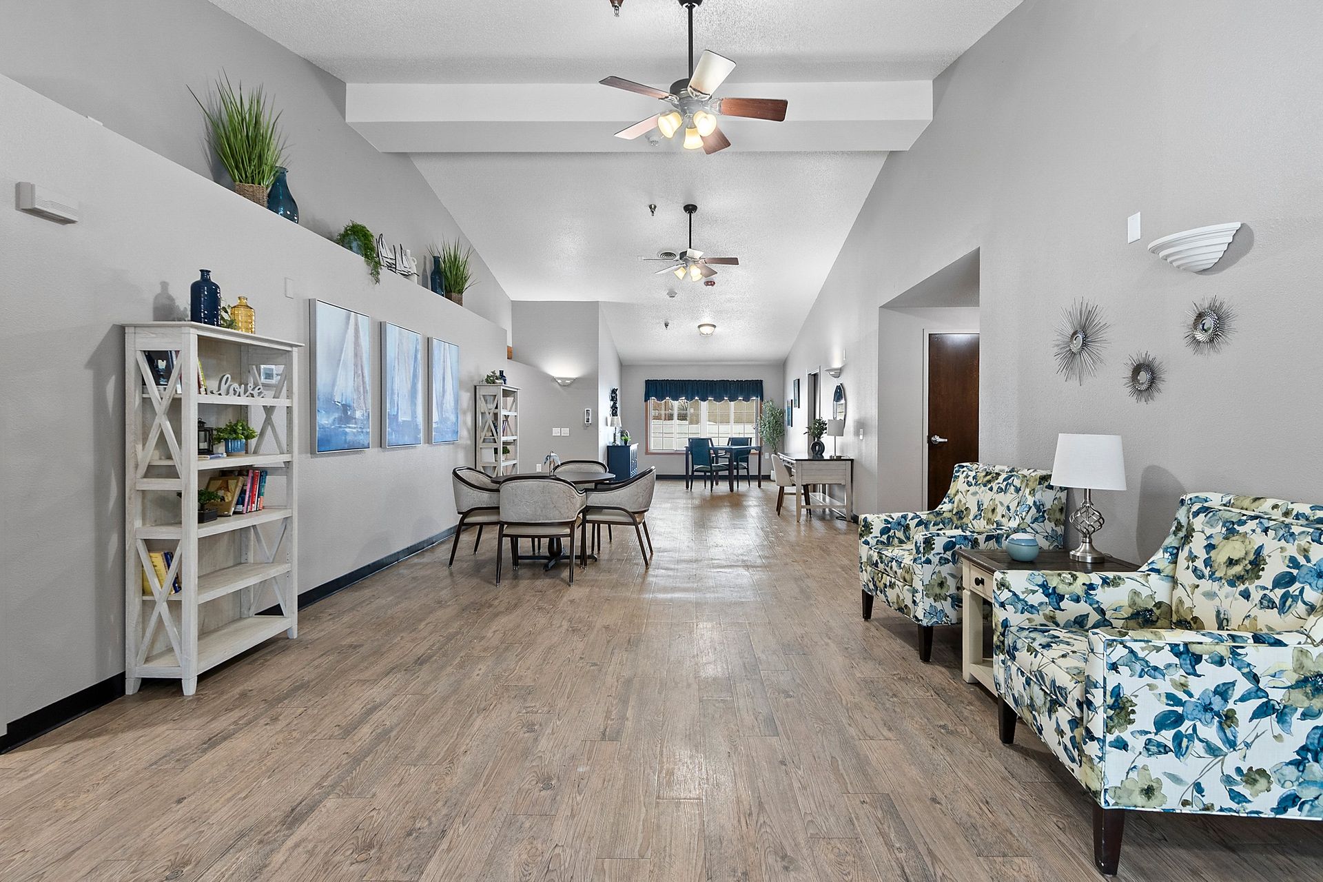 A room with tables and chairs and flowers on them