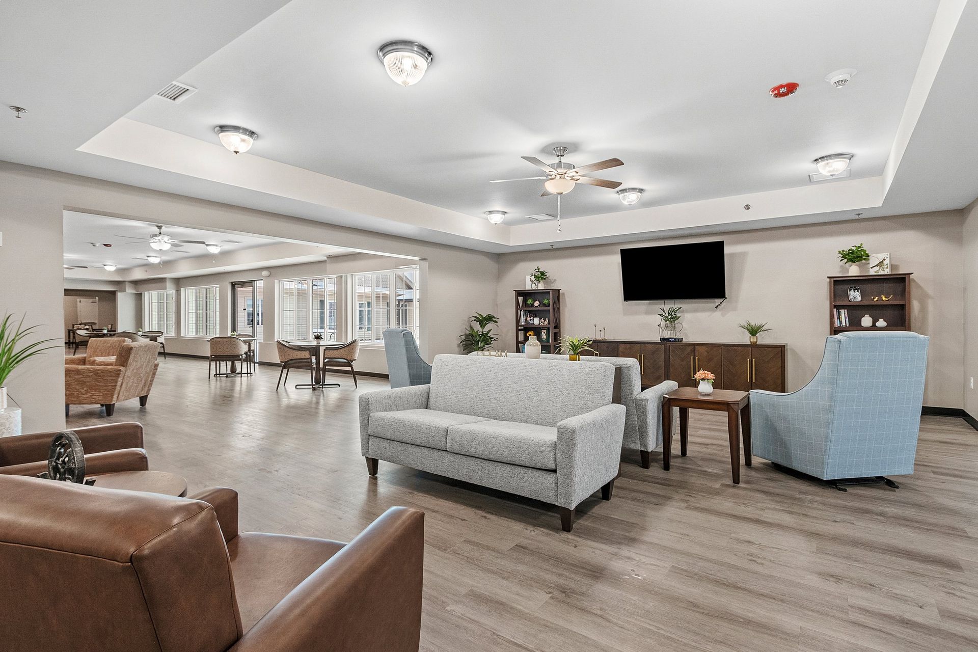 A living room filled with furniture and lots of windows.
