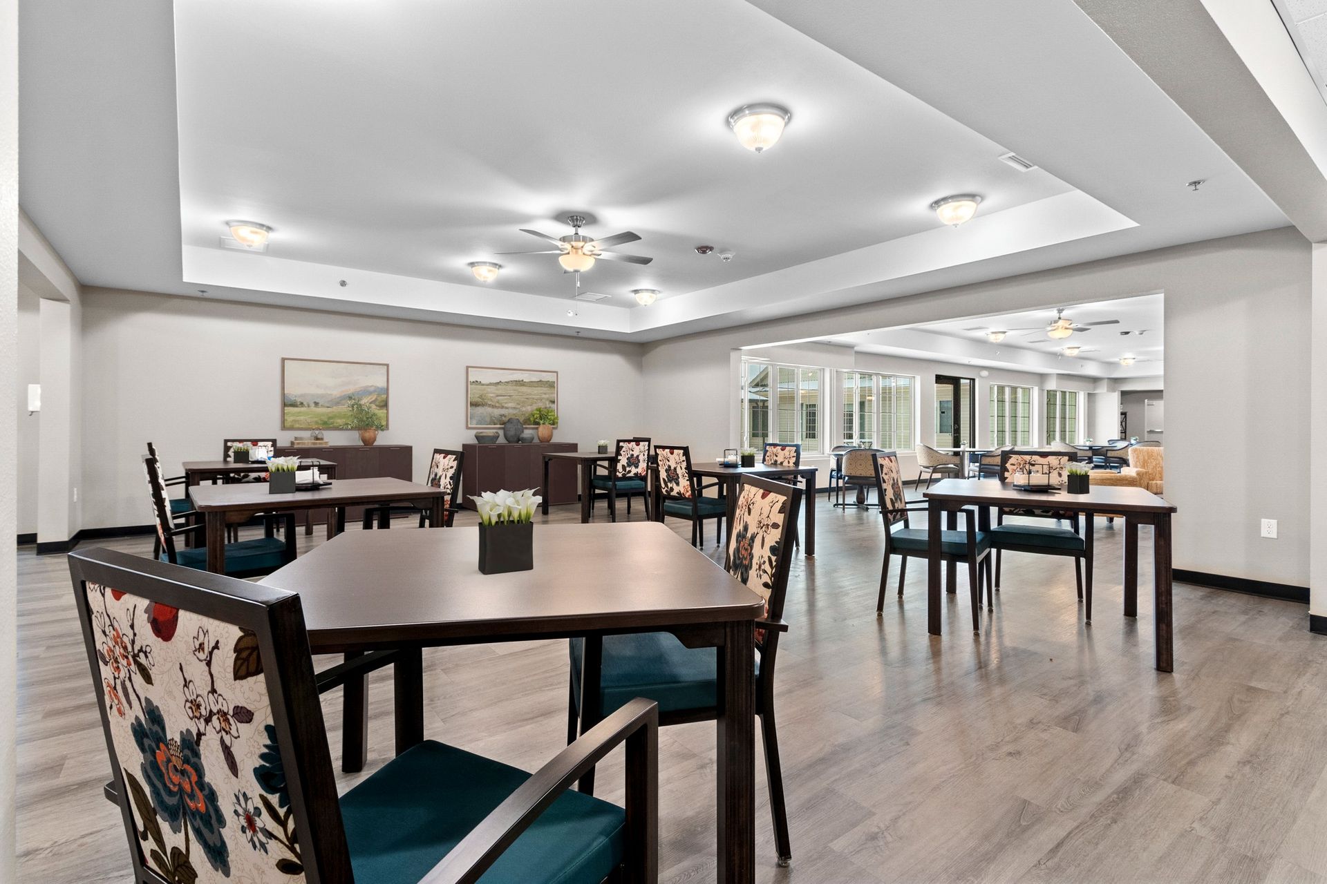 A group of people are sitting at a table in a room with a sign that says a2