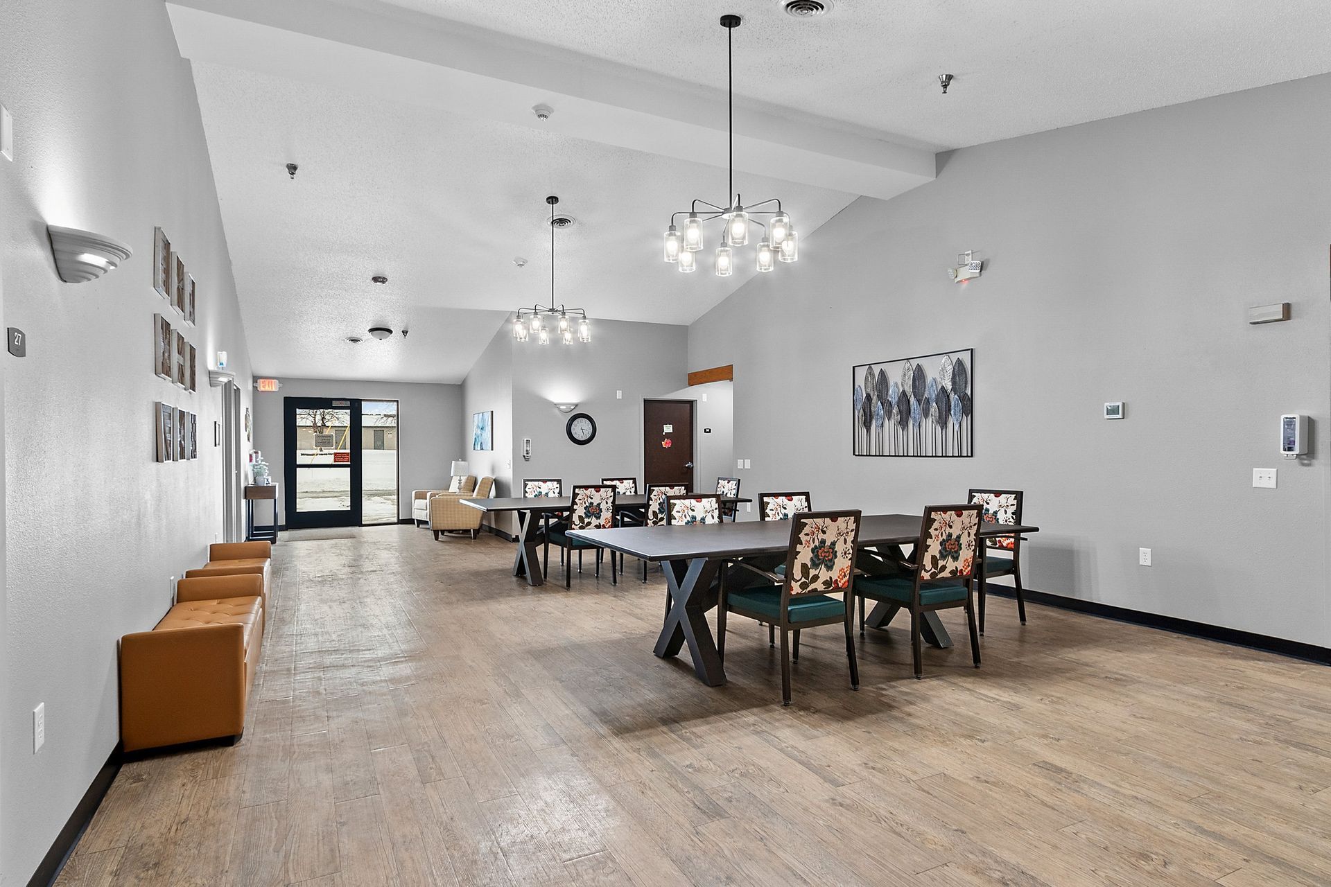 A man and a woman sit on a wooden bench in a park