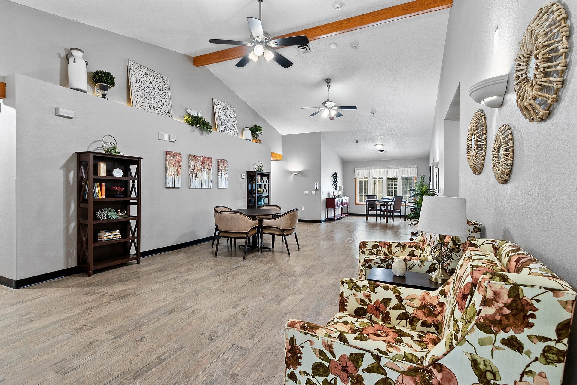 A group of elderly women are sitting at a table in a nursing home.