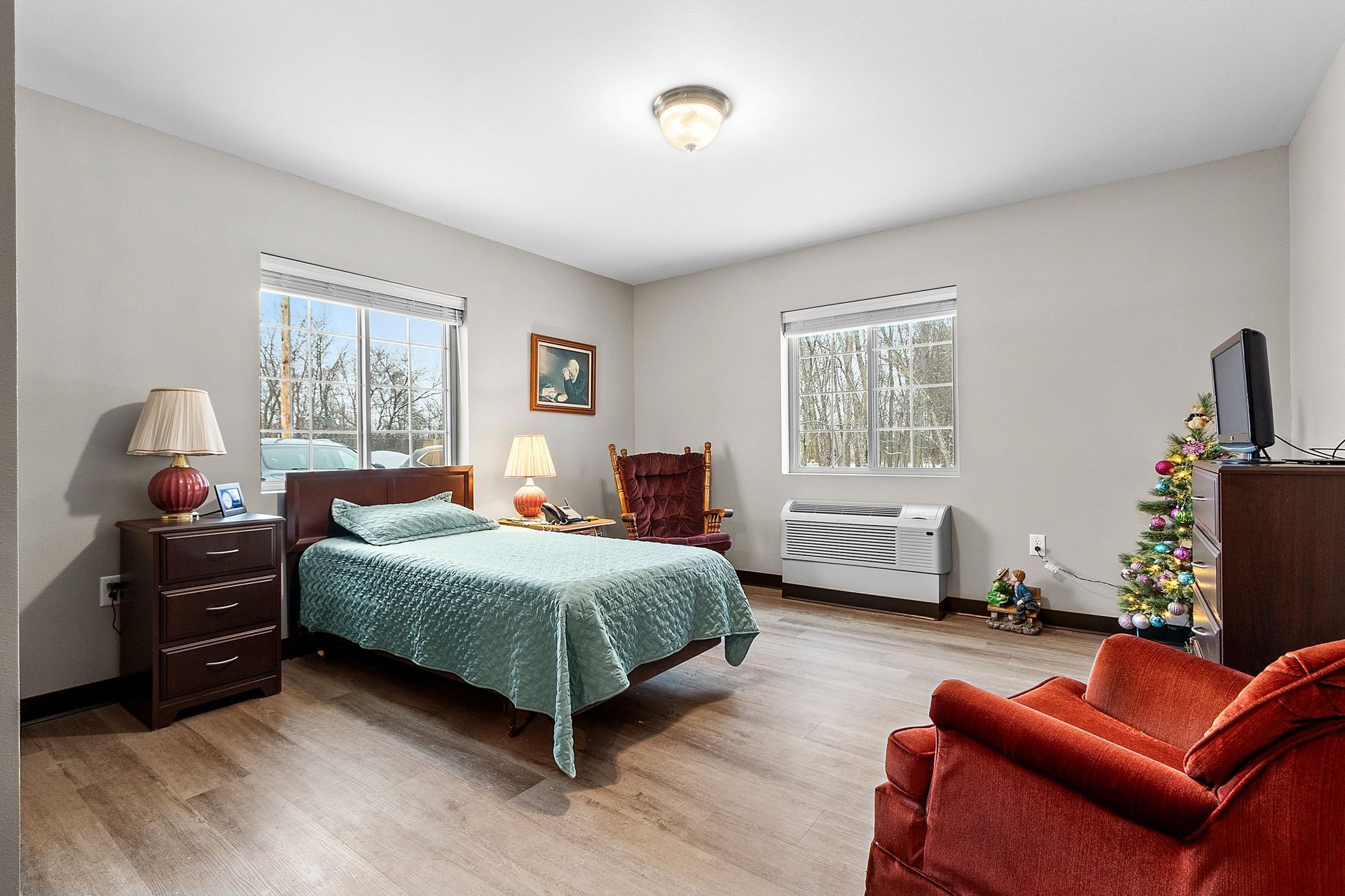 A group of elderly women in wheelchairs are doing exercises with balls.