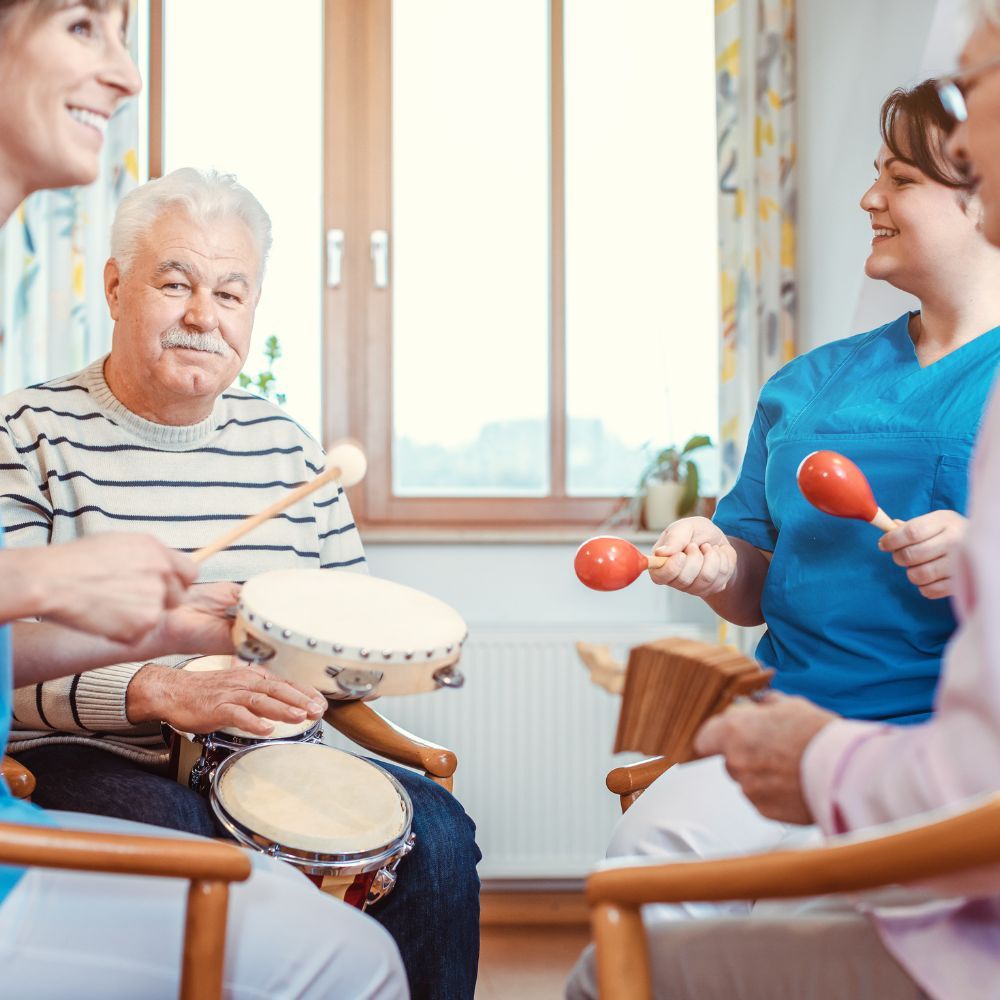 A group of people are sitting in chairs playing drums and maracas