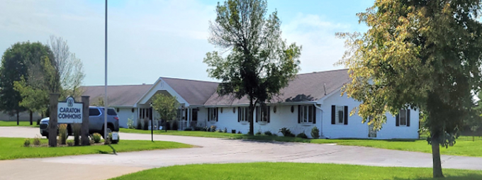 A white house with a truck parked in front of it