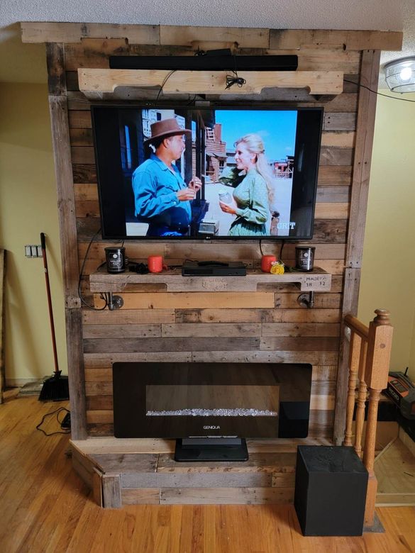 A living room with a fireplace and a flat screen tv