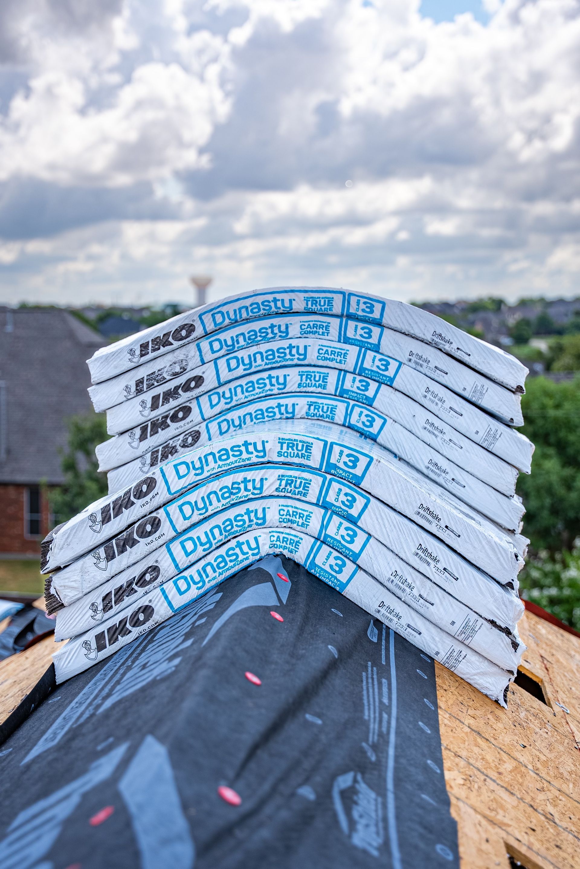 Stack of new roof shingles, labeled