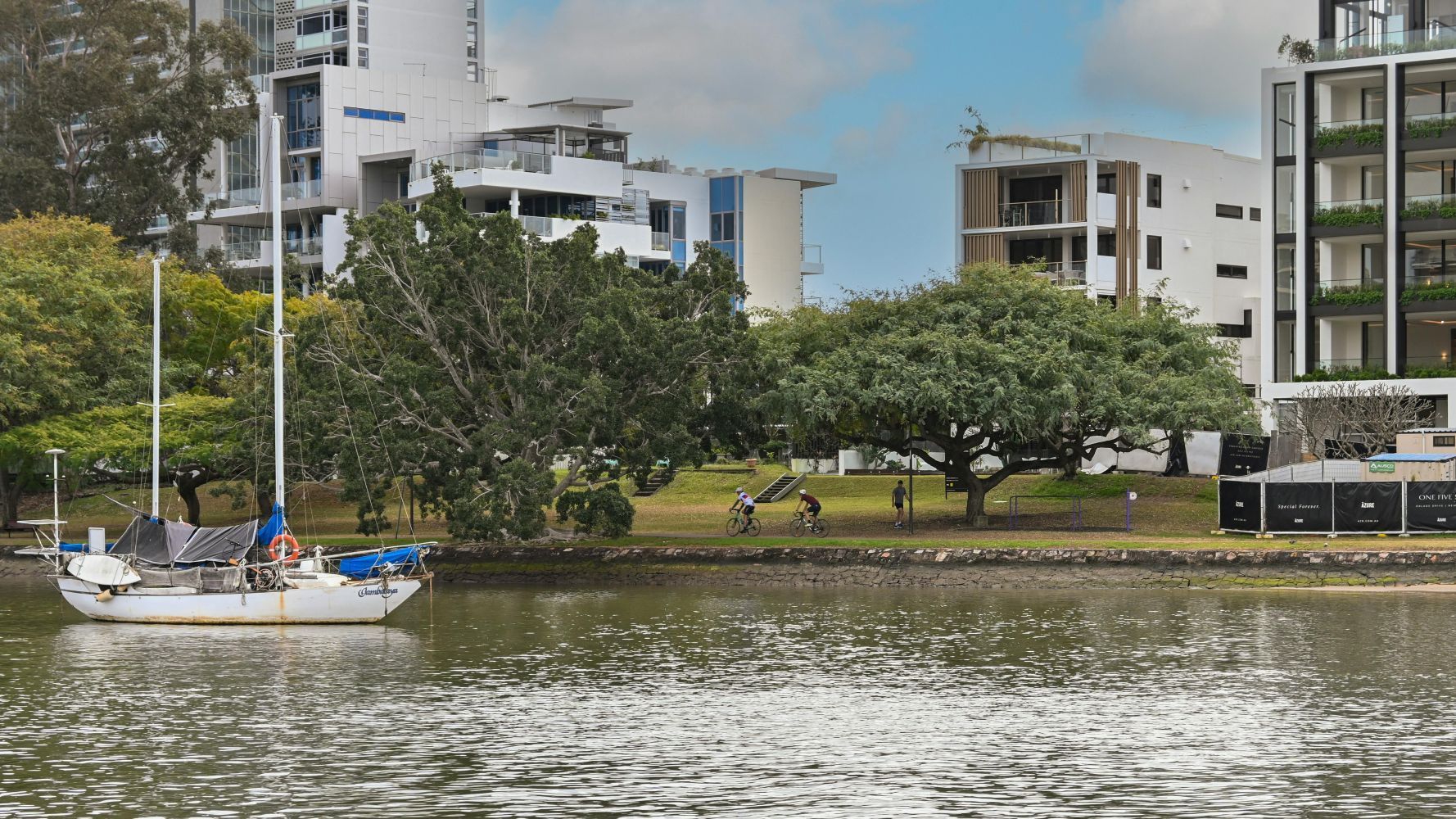 overview of Brisbane from a lake with a boat.